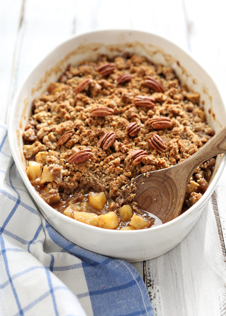 white dish of apple crisp with oatmeal topping