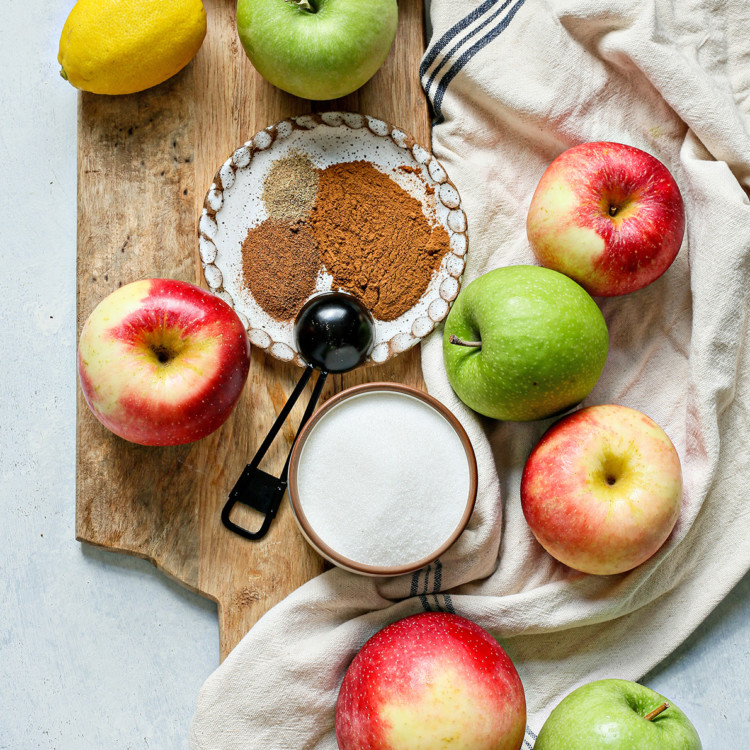 apples on a wooden cutting board