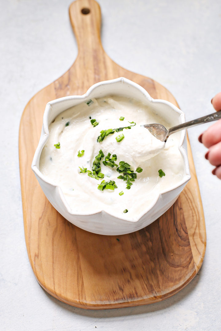 woman stirring a bowl of homemade horseradish sauce