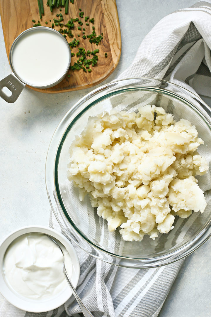 mashed potatoes in a bowl next to greek yogurt