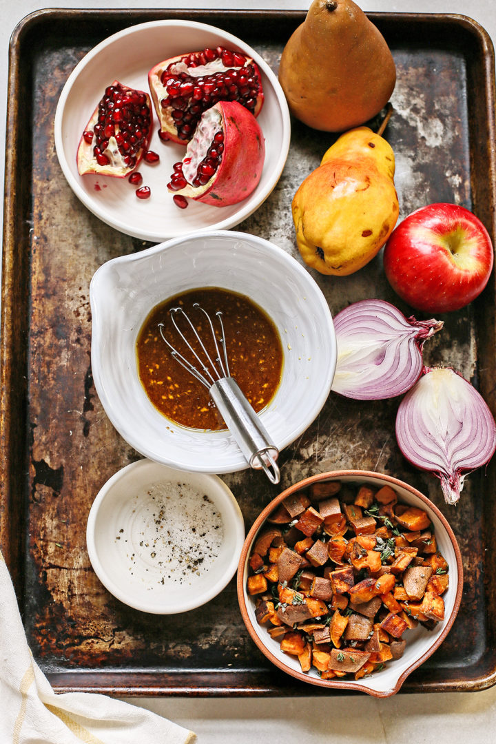 ingredients arranged on a tray to make a salad with pears