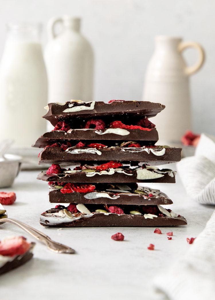 a stack of fruit and nut chocolates on a white background