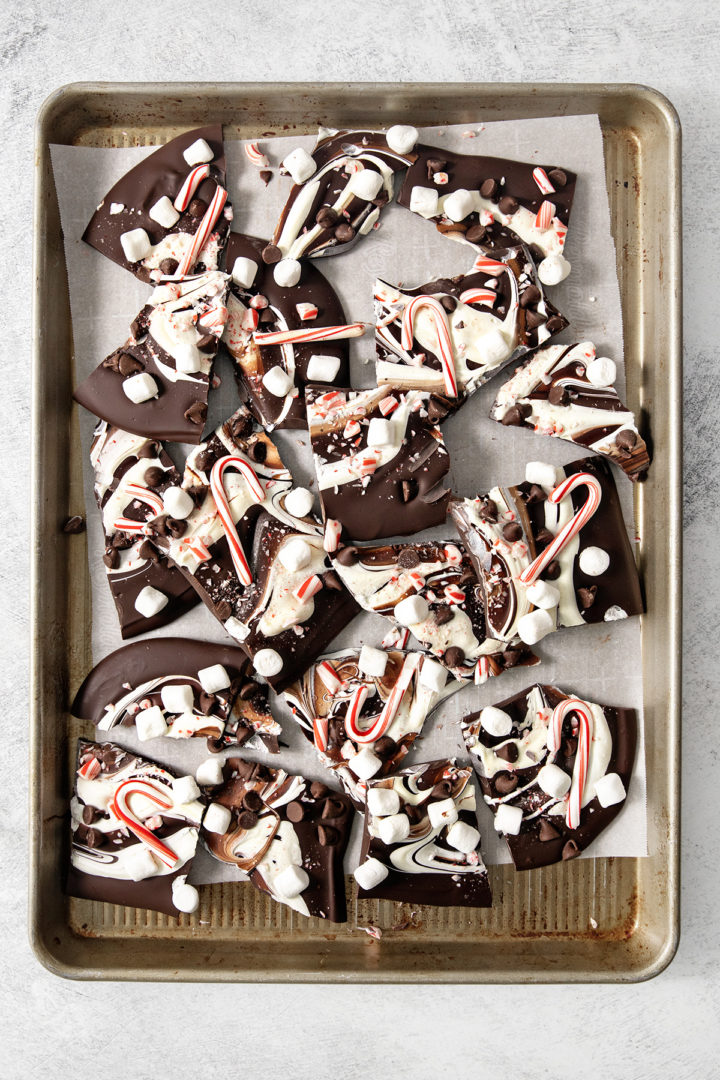a baking sheet covered in pieces of this christmas chocolate bark with peppermint 