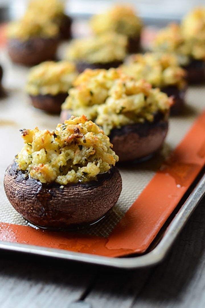 shrimp stuffed mushrooms on a baking pan