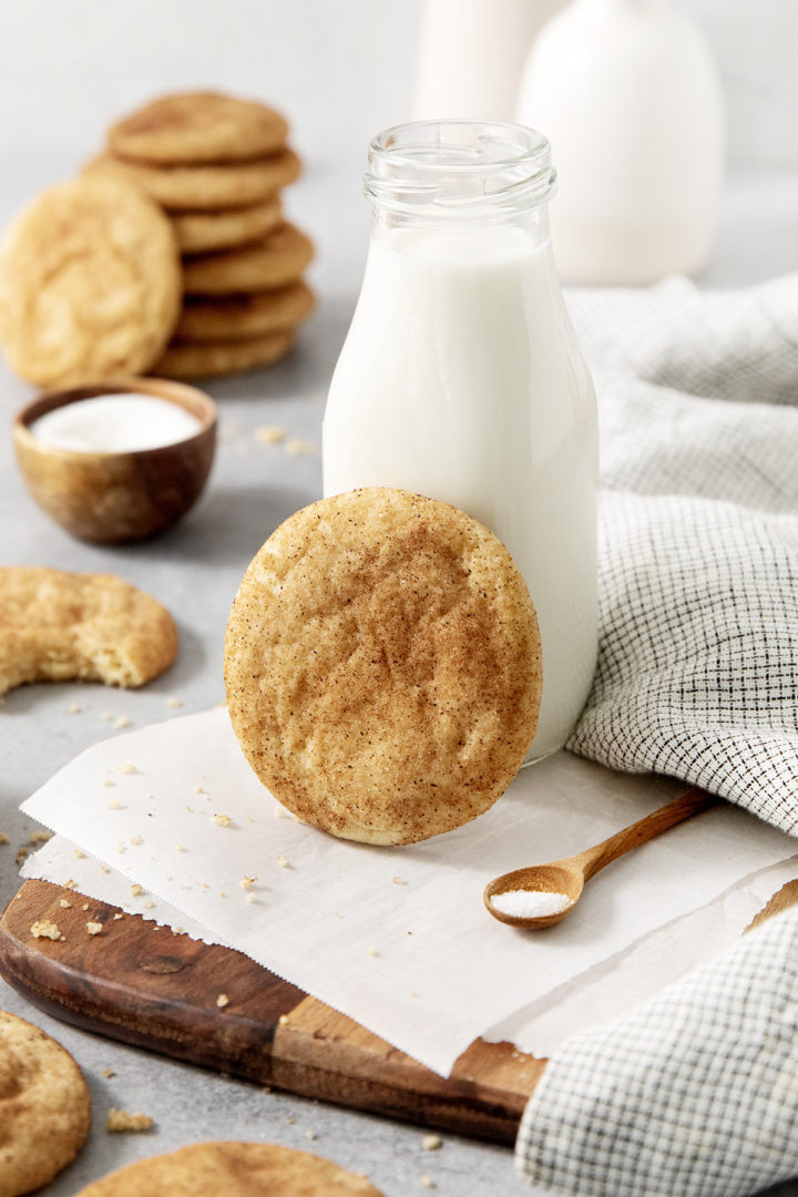 brown butter snickerdoodle next to a mug of milk