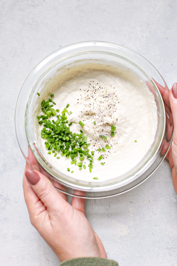 woman holding a bowl of horseradish sauce for prime rib