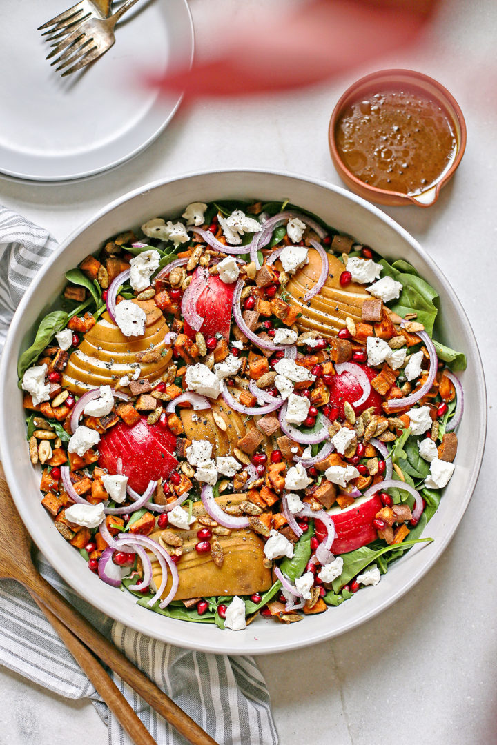 overhead photo of pear winter salad in a white bowl