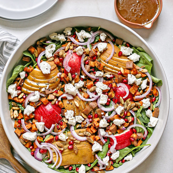overhead photo of a bowl with pear spinach salad in it