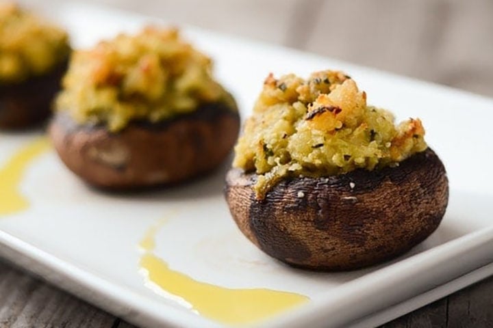 shrimp stuffed mushrooms on a white serving platter