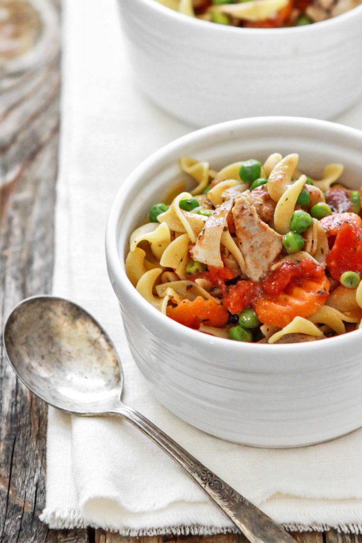 slow cooker chicken and noodles recipe served in white bowls