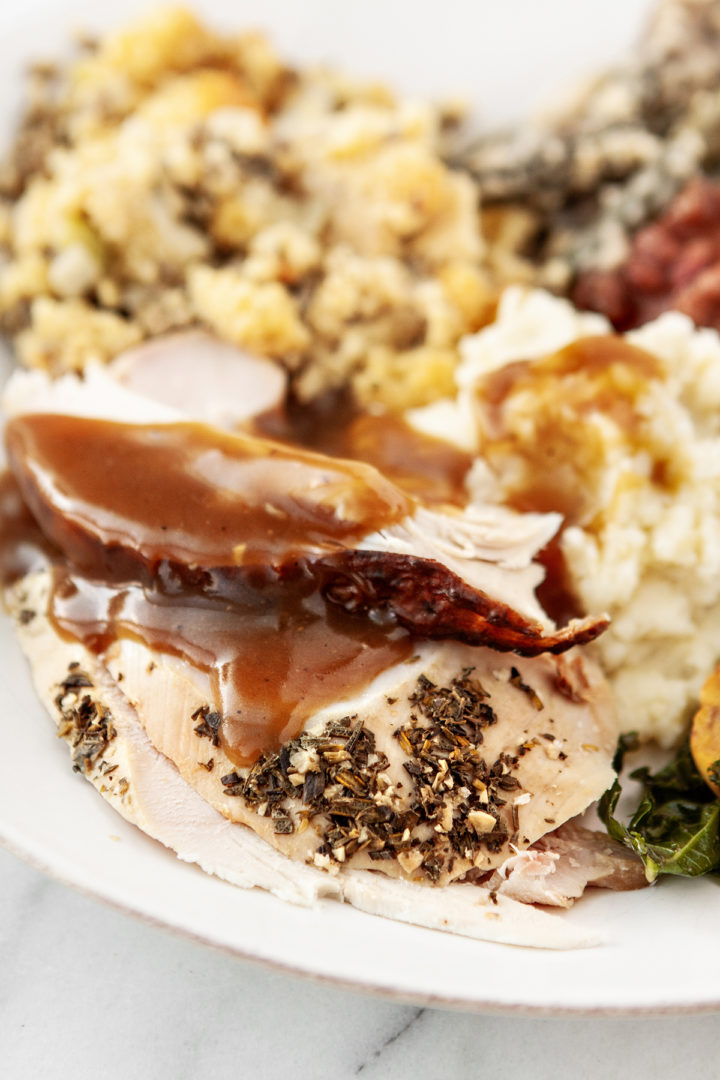 plate of smoked turkey with thanksgiving sides