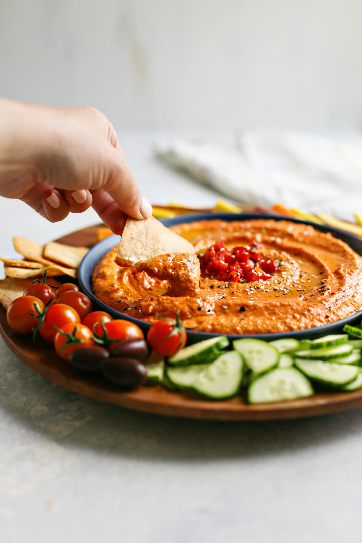 woman eating a bowl of dips for Super Bowl