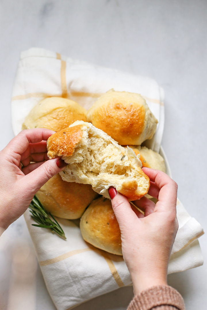 woman eating a dinner roll