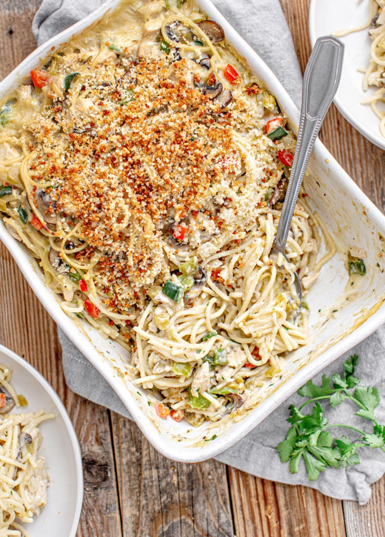 overhead photo of a turkey tetrazzini recipe baked in white casserole dish