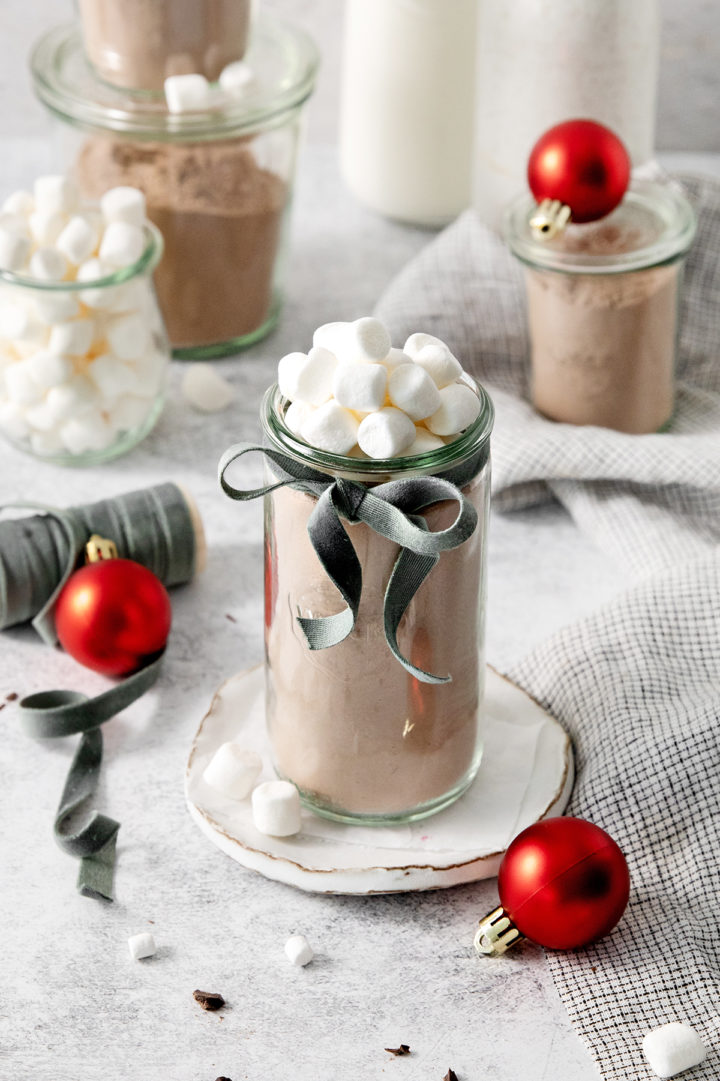 jars of homemade hot cocoa mix decorated for gifting