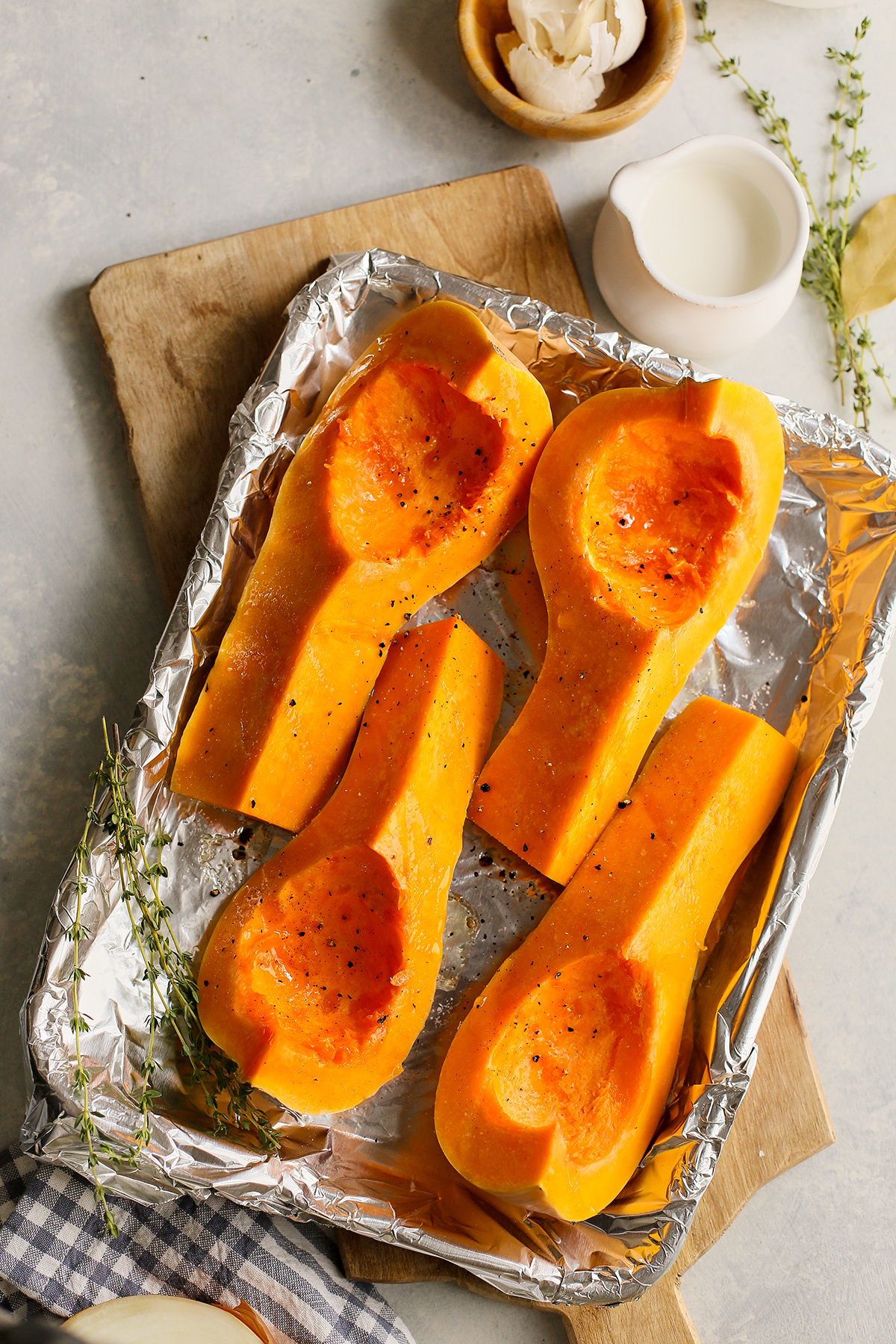 butternut squash on a baking sheet to roast for butternut and apple soup	