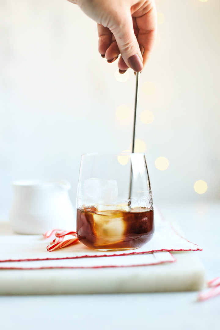 woman stirring a peppermint cocktail
