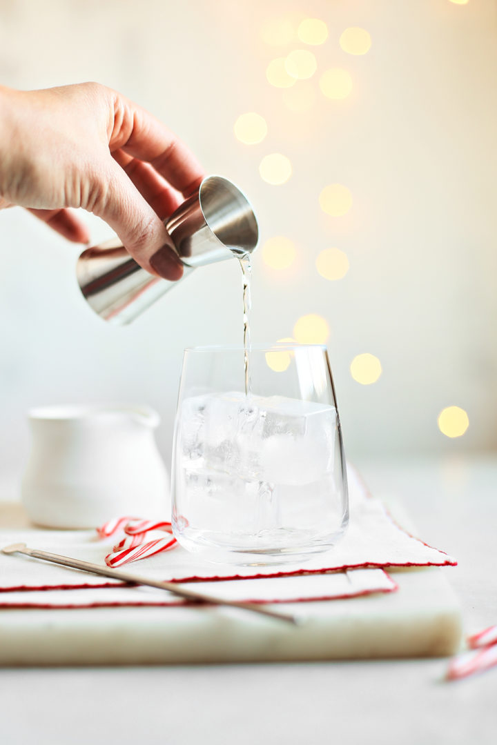 woman making a holiday peppermint white Russian
