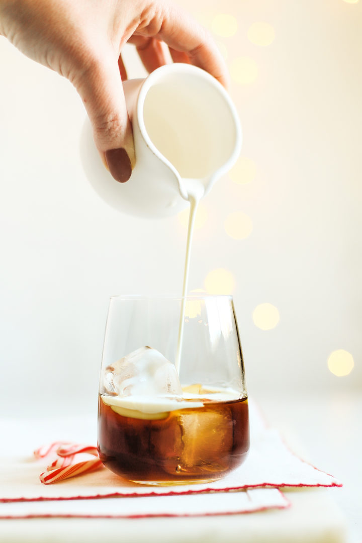 woman making a peppermint Christmas cocktail
