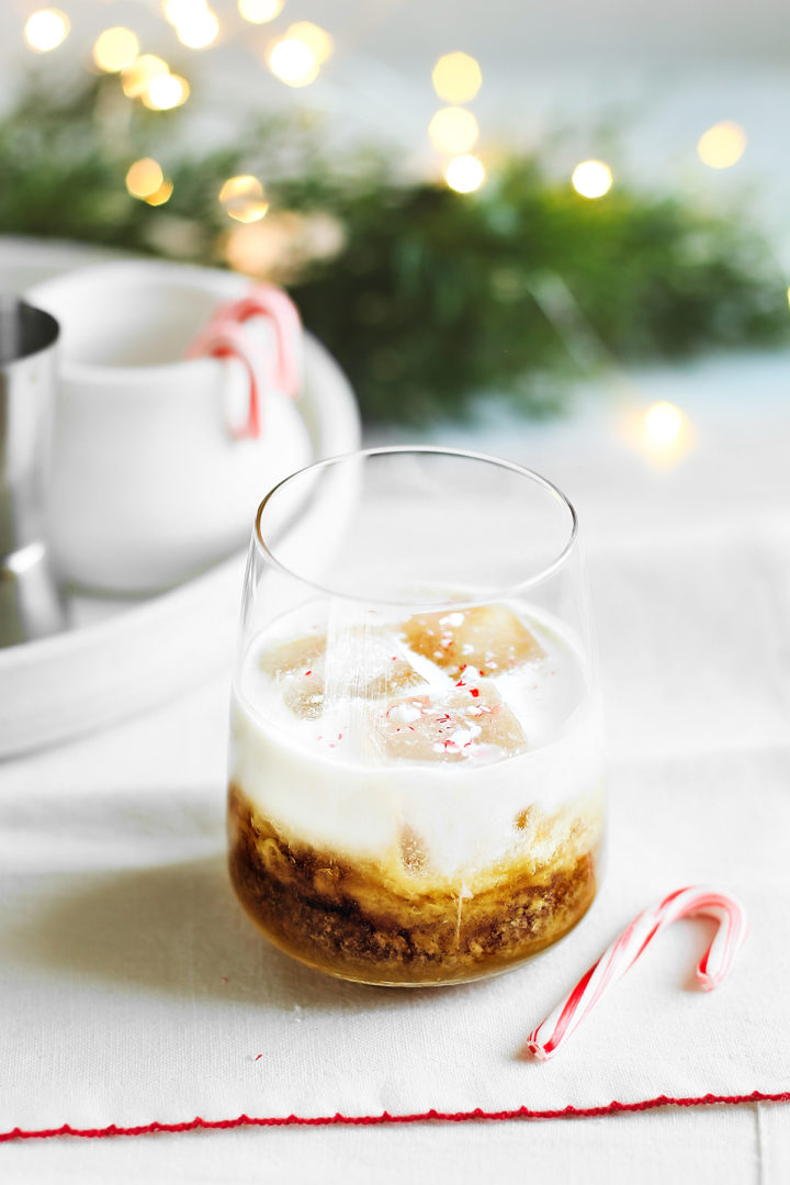 peppermint white Russian in a cocktail glass with candy cane
