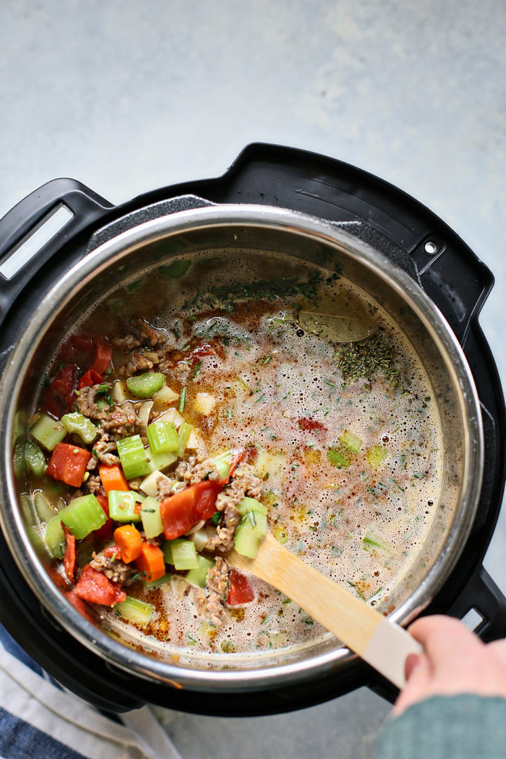 stirring italian sausage into lentil soup in Instant Pot
