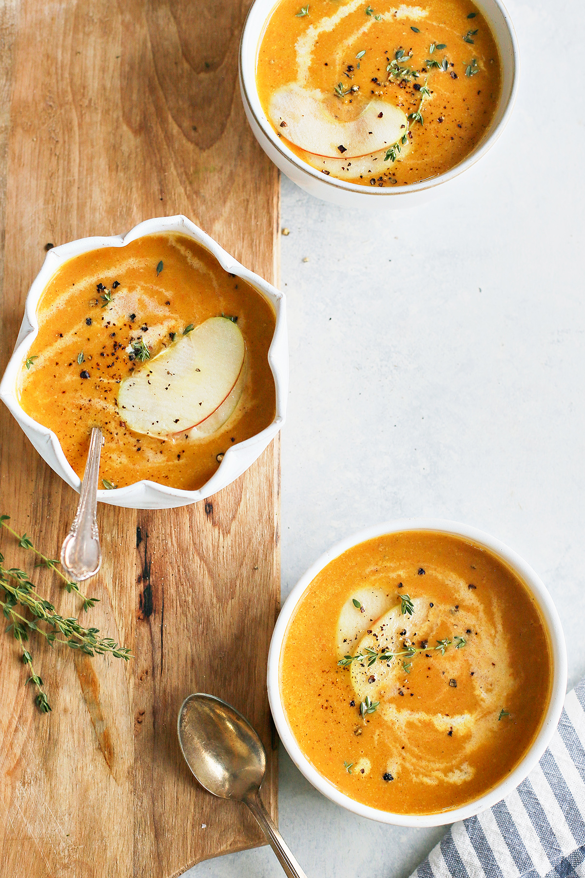 overhead photo of three bowls of butternut squash apple soup