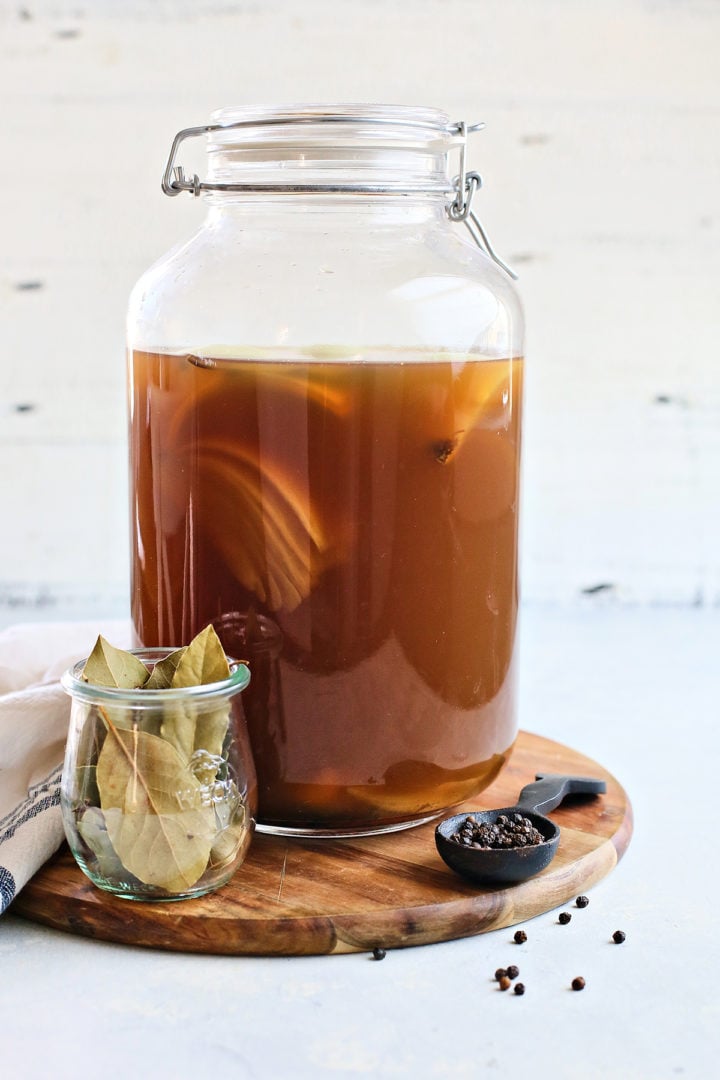 large jar with prepared brine for pork shoulder