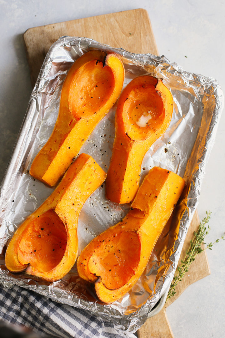 roasted butternut squash on a baking sheet to use to make a recipe for butternut and apple soup