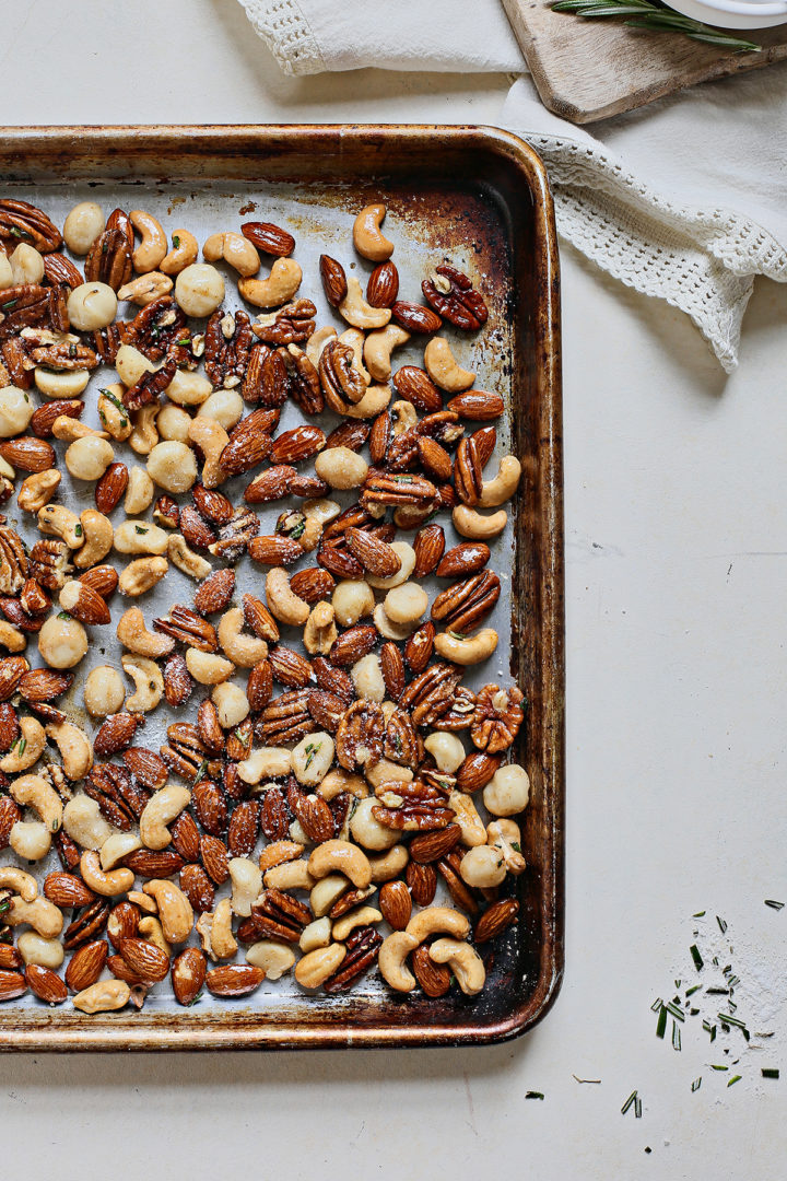 baking sheet of bar nuts with rosemary