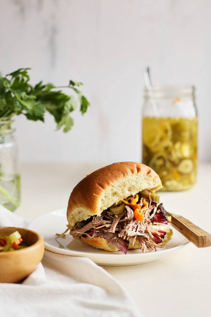 a plate with smoked pulled pork on a bun