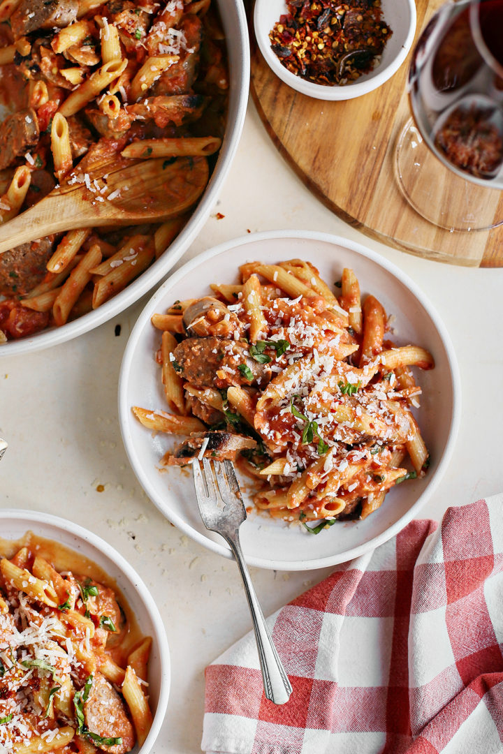 table set with bowls of penne with vodka sauce 