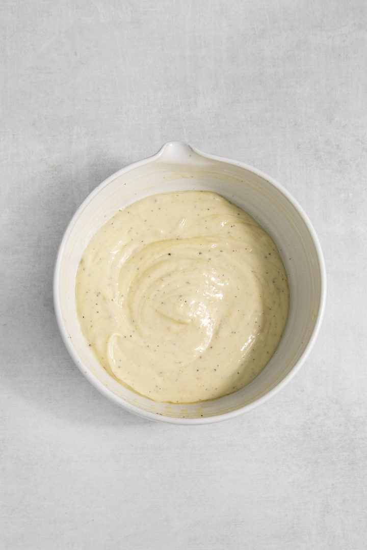 a bowl of freshly prepared aioli with roasted garlic
