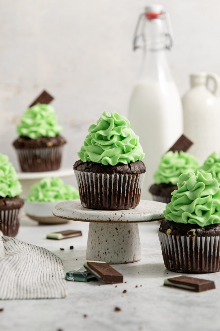 decorated mint chocolate cupcake on a cake stand