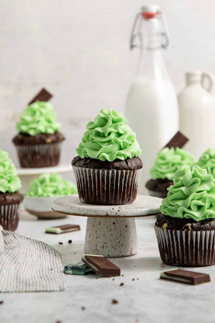 decorated mint chocolate cupcake on a cake stand