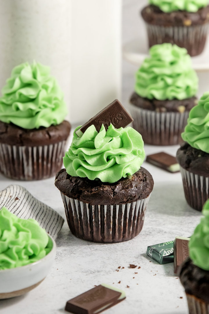 chocolate mint cupcakes with mint buttercream frosting on a light background