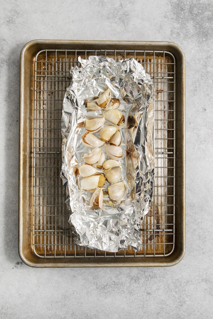 roasted garlic cloves on a sheet of foil