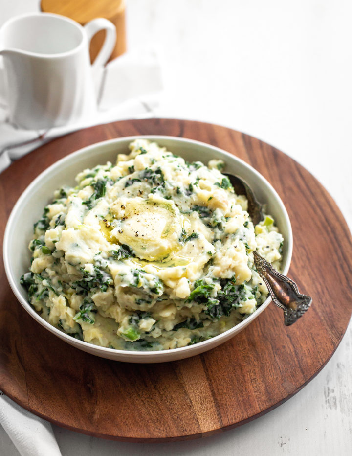 white bowl of irish mashed potatoes on a table 