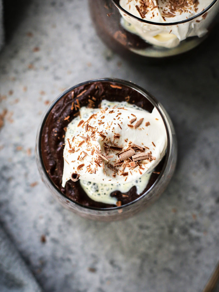 glass of chocolate pudding with whipped cream and chocolate shavings