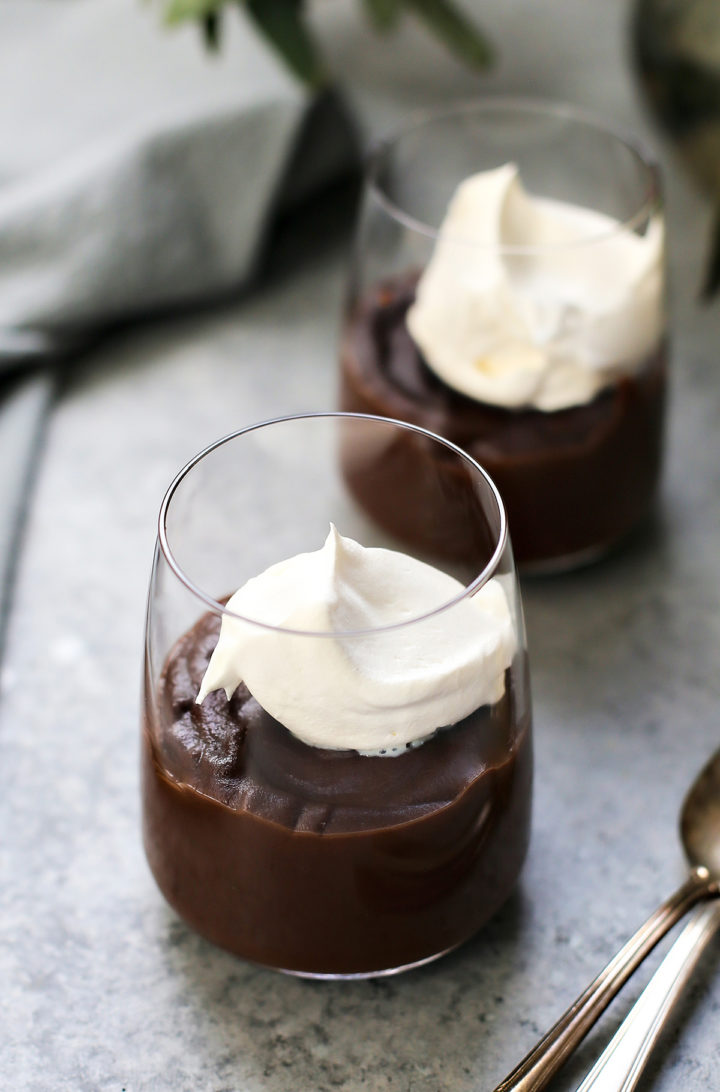 dark chocolate pudding in glasses with whipped cream
