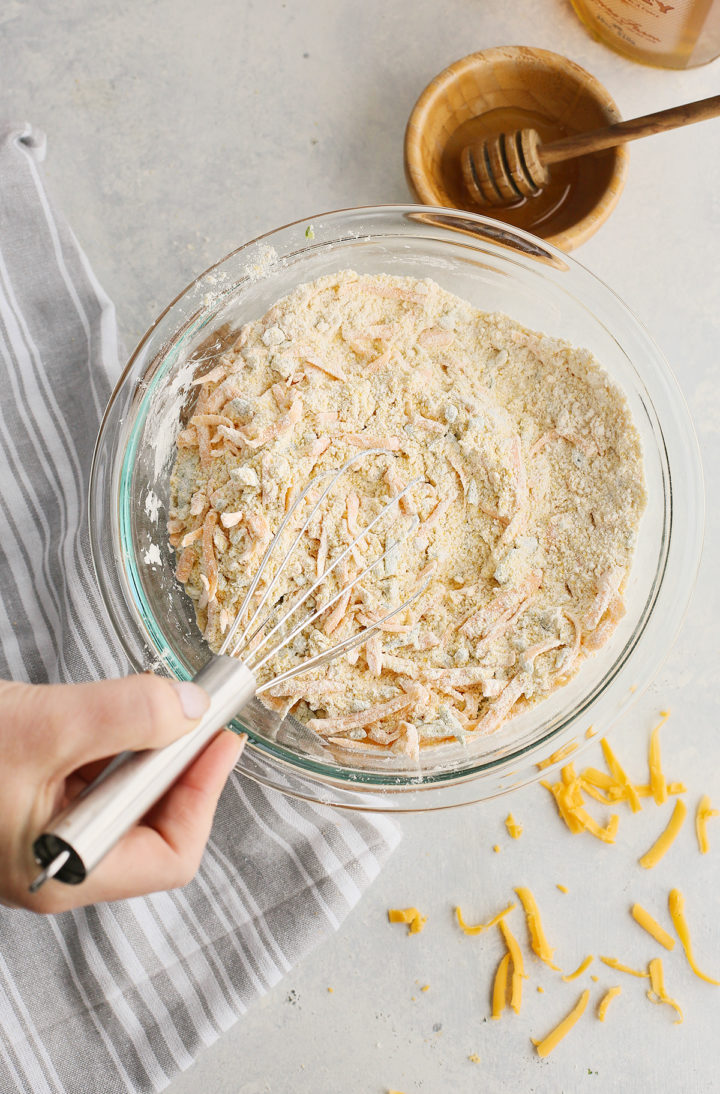 woman stirring ingredients in recipe for jalapeno cornbread