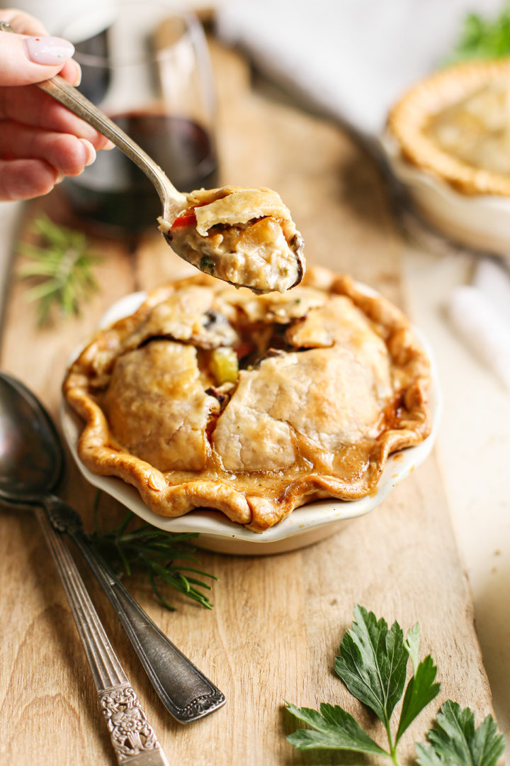 woman eating mini chicken pot pie with a spoon