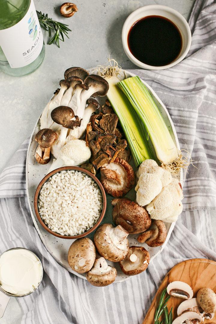 ingredients needed to make creamy mushroom risotto arranged on a plate
