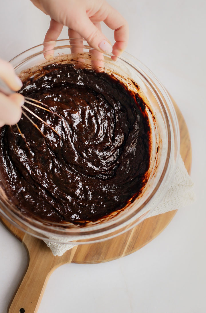 woman stirring guinness brownie batter