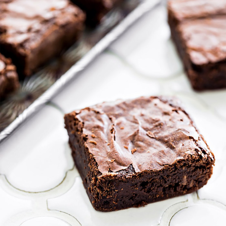 homemade brownies on a white tile counter