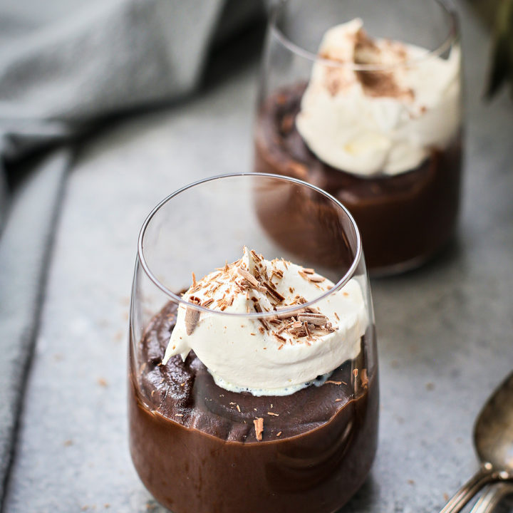 homemade chocolate pudding in glasses with whipped cream garnish