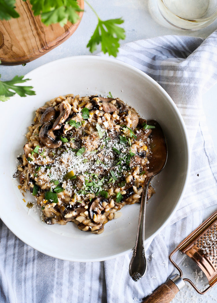 creamy mushroom risotto served in a white bowl