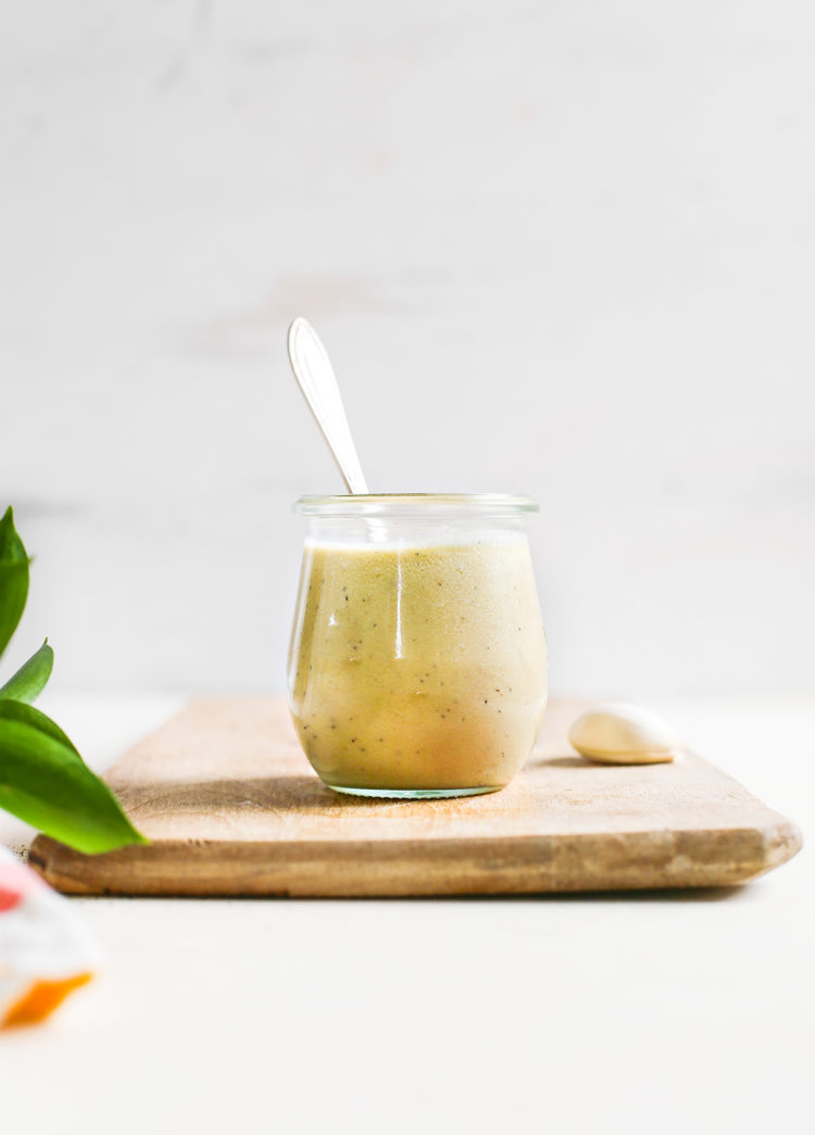 homemade caesar dressing in a jar with spoon