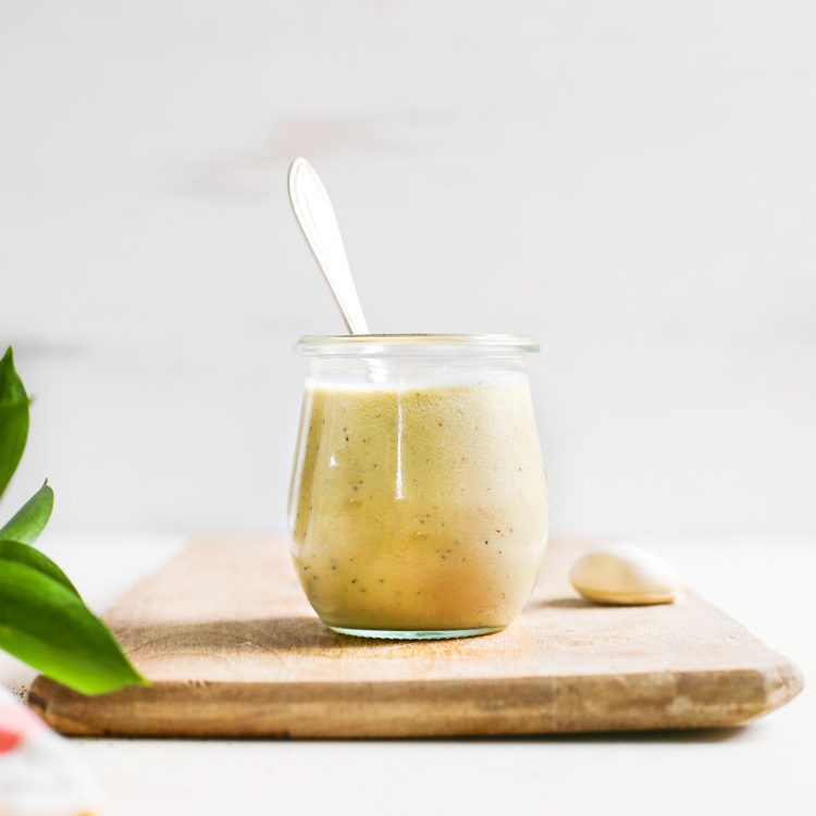 homemade caesar dressing in a jar with spoon