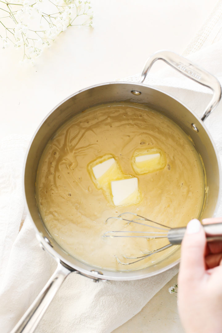 woman stirring budino dessert in a saucepan