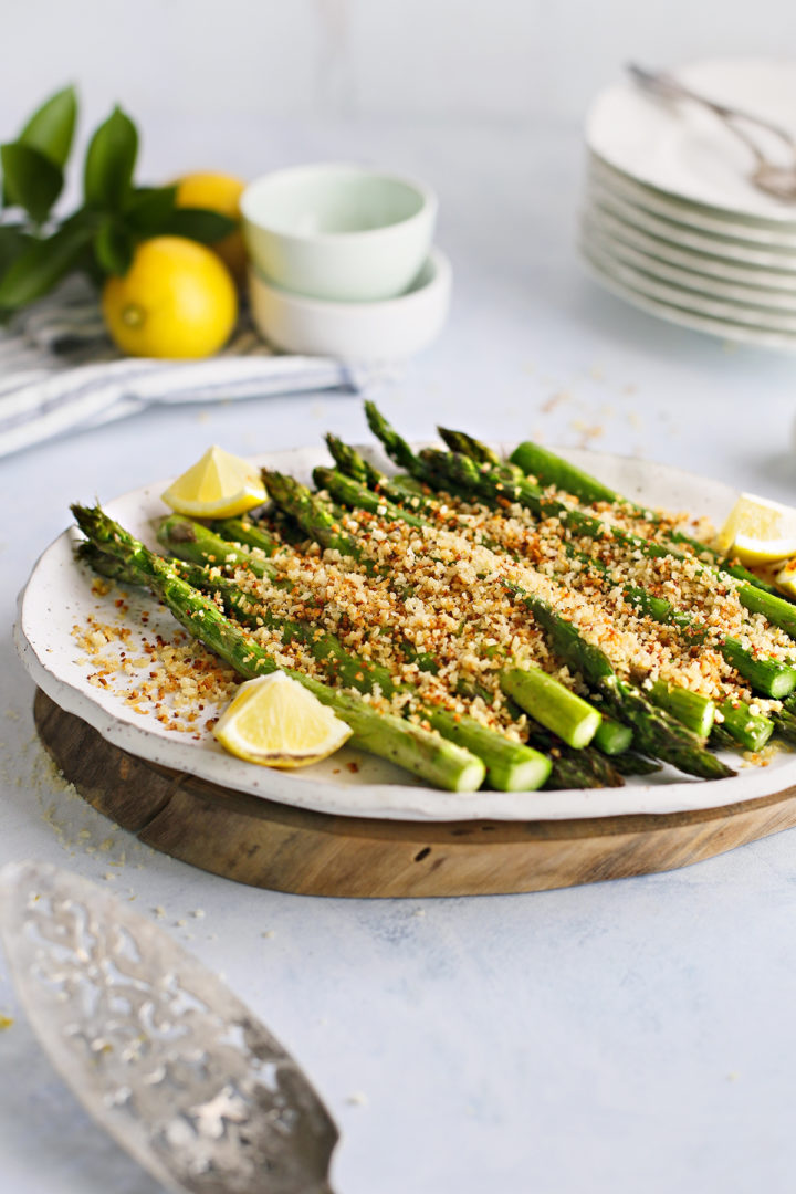 traeger asparagus with parmesan breadcrumb topping on a white platter